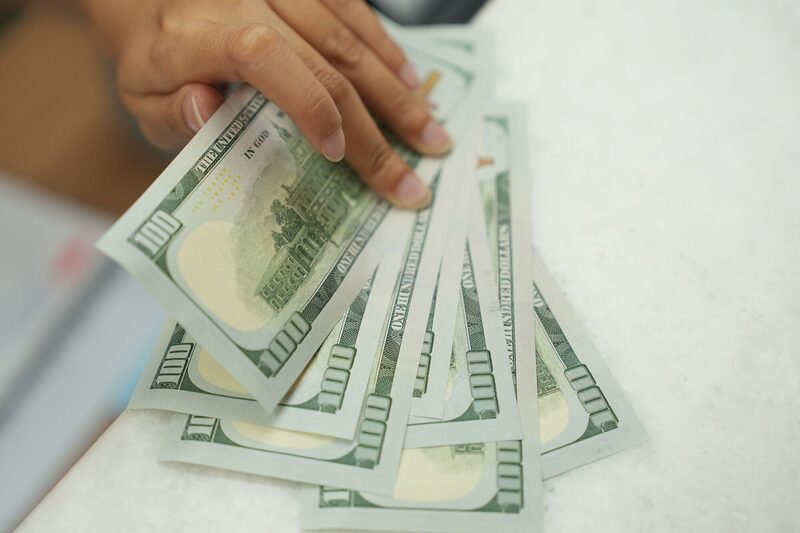 A worker holds U.S. dollar banknotes at a currency exchange office in Jakarta, Indonesia, on Thursday, Oct. 5, 2023. The dollars relentless rally has finally toppled the last Asian currency standing, with the Indonesian rupiah joining regional peers in erasing this years gains against the greenback. Photographer: Dimas Ardian/Bloomberg A worker holds U.S. dollar banknotes at a currency exchange office in Jakarta, Indonesia, on Thursday, Oct. 5, 2023. The dollars relentless rally has finally toppled the last Asian currency standing, with the Indonesian rupiah joining regional peers in erasing this years gains against the greenback. Photographer: Dimas Ardian/Bloomberg