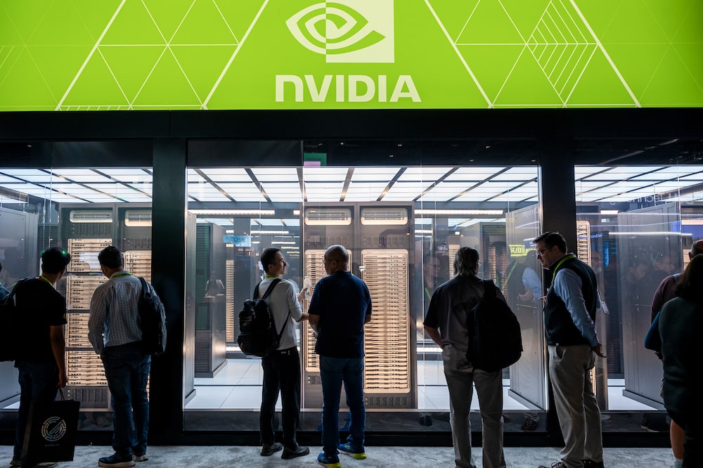 Attendees under Nvidia signage on the exhibition floor during the Nvidia GTC conference in San Jose, California, US, on Wednesday, March 18, 2026. Nvidia Corp. Chief Executive Officer Jensen Huang said the company is firing up manufacturing of H200 AI accelerators for customers in China, a sign of progress in the chipmaker's effort to reenter the vital market. Photographer: David Paul Morris/Bloomberg Attendees under Nvidia signage on the exhibition floor during the Nvidia GTC conference in San Jose, California, US, on Wednesday, March 18, 2026. Nvidia Corp. Chief Executive Officer Jensen Huang said the company is firing up manufacturing of H200 AI accelerators for customers in China, a sign of progress in the chipmaker's effort to reenter the vital market. Photographer: David Paul Morris/Bloomberg