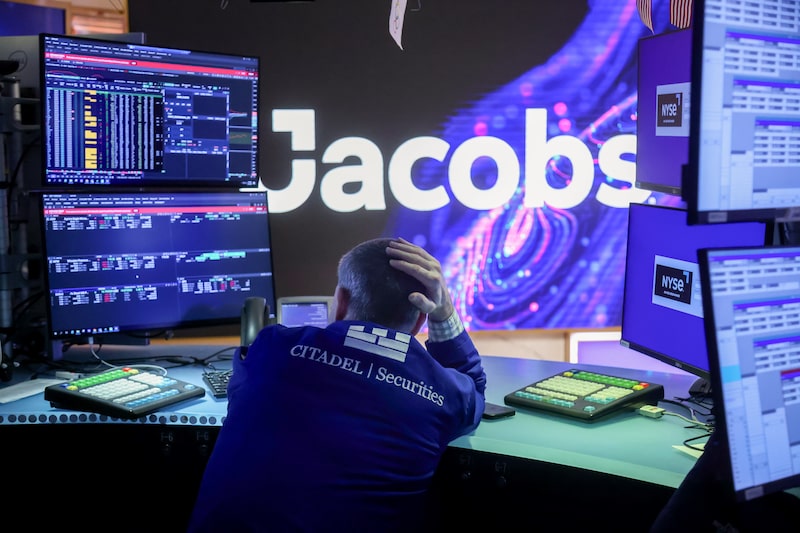 Jacobs Solutions Inc. signage as a trader works on the floor of the New York Stock Exchange (NYSE) in New York, US, on Monday, March 23, 2026. US stocks rallied on Monday after President Donald Trump ordered the Pentagon to hold off on military strikes against Iranian energy infrastructure, spurring a retreat in oil prices. Photographer: Michael Nagle/Bloomberg Jacobs Solutions Inc. signage as a trader works on the floor of the New York Stock Exchange (NYSE) in New York, US, on Monday, March 23, 2026. US stocks rallied on Monday after President Donald Trump ordered the Pentagon to hold off on military strikes against Iranian energy infrastructure, spurring a retreat in oil prices. Photographer: Michael Nagle/Bloomberg