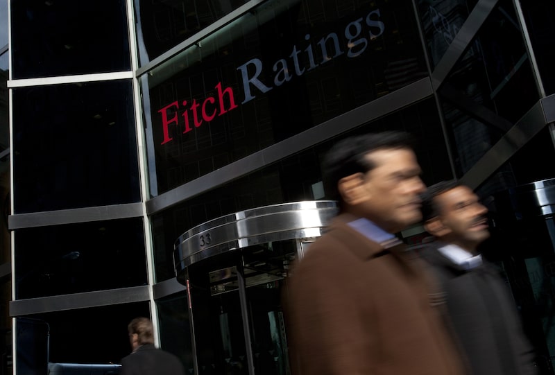 Pedestrians walk past the logo for Fitch Ratings Ltd. outside their offices in New York, U.S., on Tuesday, Feb. 21, 2012. Fitch provides the world's credit markets with independent and prospective credit opinions, research, and data. Fitch also provides enterprise risk management solutions. Photographer: Scott Eells/Bloomberg Pedestrians walk past the logo for Fitch Ratings Ltd. outside their offices in New York, U.S., on Tuesday, Feb. 21, 2012. Fitch provides the world's credit markets with independent and prospective credit opinions, research, and data. Fitch also provides enterprise risk management solutions. Photographer: Scott Eells/Bloomberg