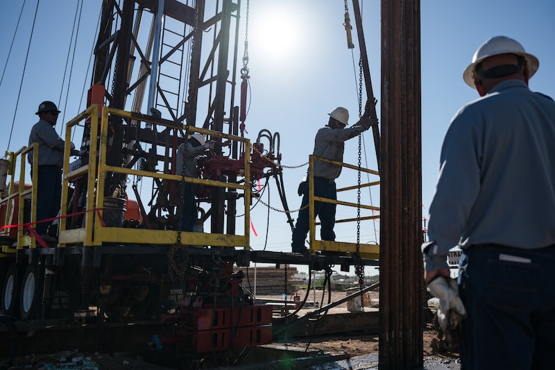 An oilfield crew works at a service rig in Midland, Texas. An oilfield crew works at a service rig in Midland, Texas.
