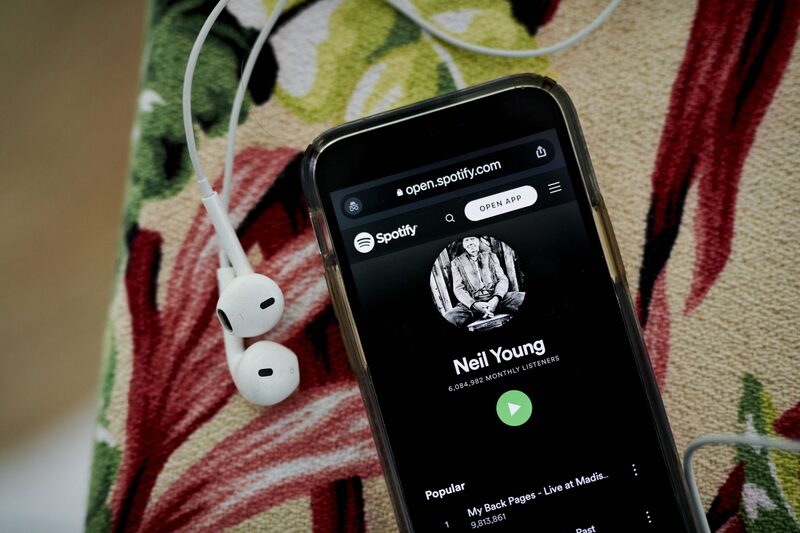 The Neil Young Spotify website page on a smartphone in Saint Thomas, U.S. Virgin Islands, on Sunday, January 30, 2022. Spotify Technology SA outlined steps it will take to halt the spread of misleading information about Covid-19 on its audio-streaming service in an attempt to quell a growing controversy over its support for the podcast host Joe Rogan. Photographer: Gabby Jones/Bloomberg The Neil Young Spotify website page on a smartphone in Saint Thomas, U.S. Virgin Islands, on Sunday, January 30, 2022. Spotify Technology SA outlined steps it will take to halt the spread of misleading information about Covid-19 on its audio-streaming service in an attempt to quell a growing controversy over its support for the podcast host Joe Rogan. Photographer: Gabby Jones/Bloomberg
