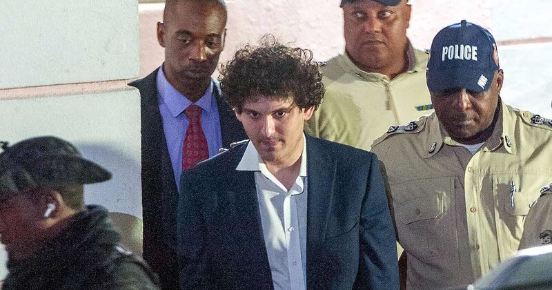 FTX founder Sam Bankman-Fried (C) is led away handcuffed by officers of the Royal Bahamas Police Force in Nassau, Bahamas on December 13, 2022. FTX founder Sam Bankman-Fried (C) is led away handcuffed by officers of the Royal Bahamas Police Force in Nassau, Bahamas on December 13, 2022.
