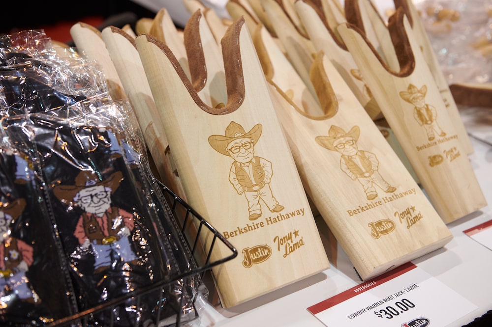 Products depicting former Berkshire Hathaway CEO Warren Buffett at the Justin booth inside the convention hall during a shareholders shopping day ahead of the Berkshire Hathaway annual shareholders meeting in Omaha, Nebraska, US, on Friday, May 1, 2026. CEO Greg Abel has pledged to follow Buffett's approach to investing and managing risk - Saturday's meeting is branded with the slogan "The Legacy Continues." Photographer: Dan Brouillette/Bloomberg Products depicting former Berkshire Hathaway CEO Warren Buffett at the Justin booth inside the convention hall during a shareholders shopping day ahead of the Berkshire Hathaway annual shareholders meeting in Omaha, Nebraska, US, on Friday, May 1, 2026. CEO Greg Abel has pledged to follow Buffett's approach to investing and managing risk - Saturday's meeting is branded with the slogan "The Legacy Continues." Photographer: Dan Brouillette/Bloomberg