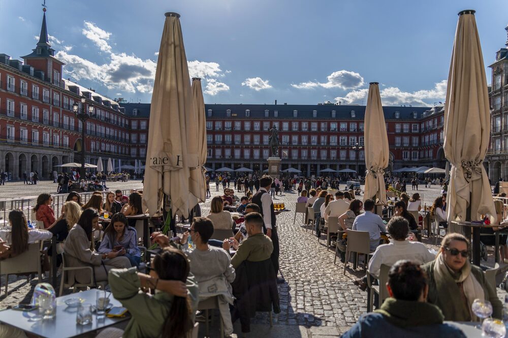 Customers dine at outside tables of a restaurant terrace in Plaza Mayor square, Madrid, Spain, on Saturday, April 17, 2021. European travel and leisure stocks have gained 20% this year on the expectation that an accelerating vaccine rollout will pave the way for normal travel patterns after a yearlong slump in air traffic and hotel-stays induced by the pandemic. Photographer: Paul Hanna/Bloomberg Customers dine at outside tables of a restaurant terrace in Plaza Mayor square, Madrid, Spain, on Saturday, April 17, 2021. European travel and leisure stocks have gained 20% this year on the expectation that an accelerating vaccine rollout will pave the way for normal travel patterns after a yearlong slump in air traffic and hotel-stays induced by the pandemic. Photographer: Paul Hanna/Bloomberg