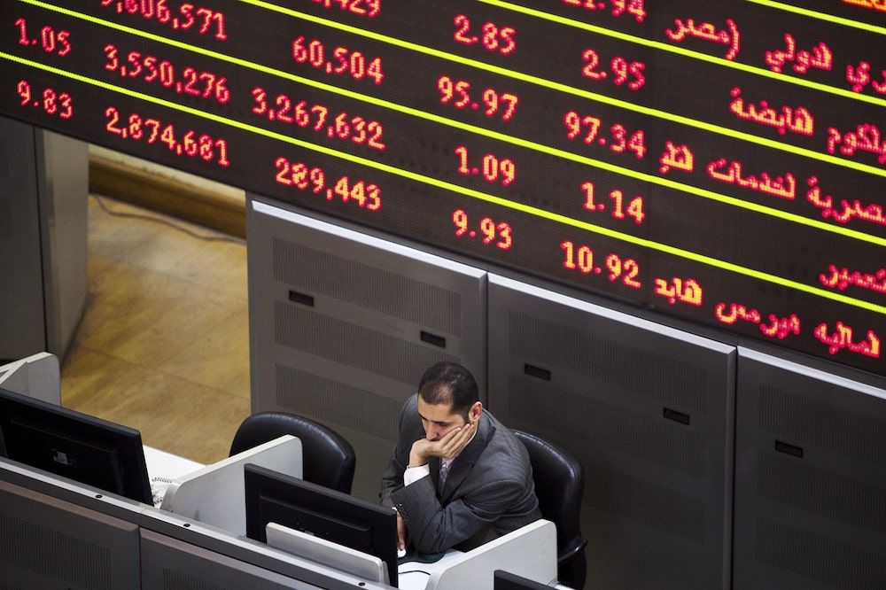 A financial trader sits at his desk beneath a screen displaying financial data inside the Egyptian stock exchange in Cairo, Egypt, on Tuesday, Nov. 22, 2011. Egypt's benchmark dollar bonds slumped, sending the yield to the highest level since January, after concessions made by the country's military rulers were rejected by protesters demanding a civilian government. Photographer: Shawn Baldwin/Bloomberg A financial trader sits at his desk beneath a screen displaying financial data inside the Egyptian stock exchange in Cairo, Egypt, on Tuesday, Nov. 22, 2011. Egypt's benchmark dollar bonds slumped, sending the yield to the highest level since January, after concessions made by the country's military rulers were rejected by protesters demanding a civilian government. Photographer: Shawn Baldwin/Bloomberg