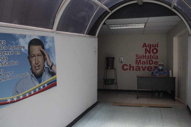 An image of the late President Hugo Chavez at the entrance of the Ana Francisca Perez de Leon II hospital in Caracas, Venezuela, on Wednesday, Aug. 26, 2020. Venezuela, which registered few coronavirus cases in the first months of the pandemic, is now facing a spike and is embracing China's approach of forced isolation combined with other top-down measures. Photographer: Carlos Becerra/Bloomberg An image of the late President Hugo Chavez at the entrance of the Ana Francisca Perez de Leon II hospital in Caracas, Venezuela, on Wednesday, Aug. 26, 2020. Venezuela, which registered few coronavirus cases in the first months of the pandemic, is now facing a spike and is embracing China's approach of forced isolation combined with other top-down measures. Photographer: Carlos Becerra/Bloomberg