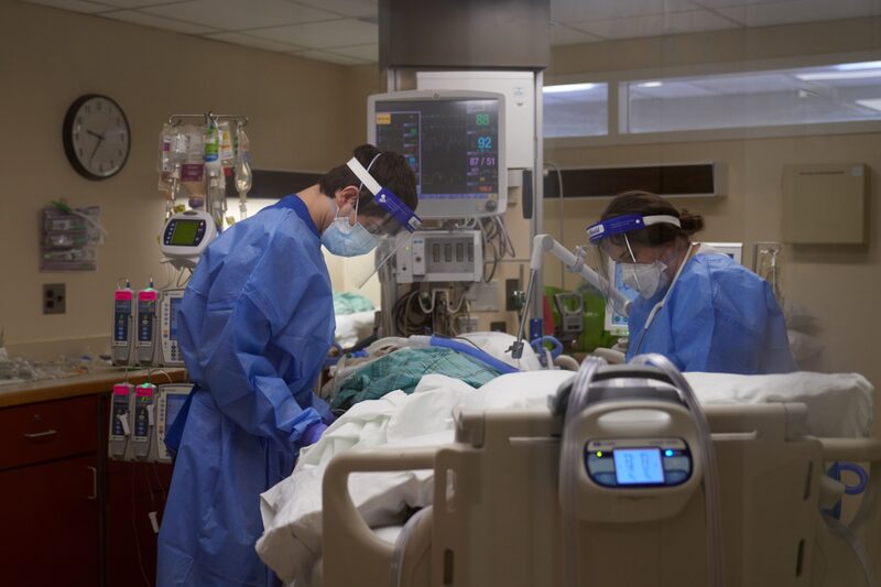 Healthcare workers treat a Covid-19 patient on the Intensive Care Unit (ICU) floor at Hartford Hospital in Hartford, Connecticut, U.S., on Monday, Jan. 31, 2022. Connecticut's test positivity rate dropped this week and has remained below 10% and hospitalizations are below 1,100 for the first time since late December. Photographer: Allison Dinner/Bloomberg Healthcare workers treat a Covid-19 patient on the Intensive Care Unit (ICU) floor at Hartford Hospital in Hartford, Connecticut, U.S., on Monday, Jan. 31, 2022. Connecticut's test positivity rate dropped this week and has remained below 10% and hospitalizations are below 1,100 for the first time since late December. Photographer: Allison Dinner/Bloomberg