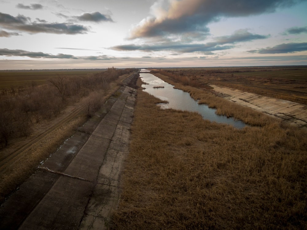 A section of the Northern Crimean Canal where it becomes dry, below a makeshift dam in the Kalanchatski region of Kherson Oblast, Ukraine. The dam has blocked water from reaching Crimea, approximately 25 kilometers south, since 2014. A section of the Northern Crimean Canal where it becomes dry, below a makeshift dam in the Kalanchatski region of Kherson Oblast, Ukraine. The dam has blocked water from reaching Crimea, approximately 25 kilometers south, since 2014.