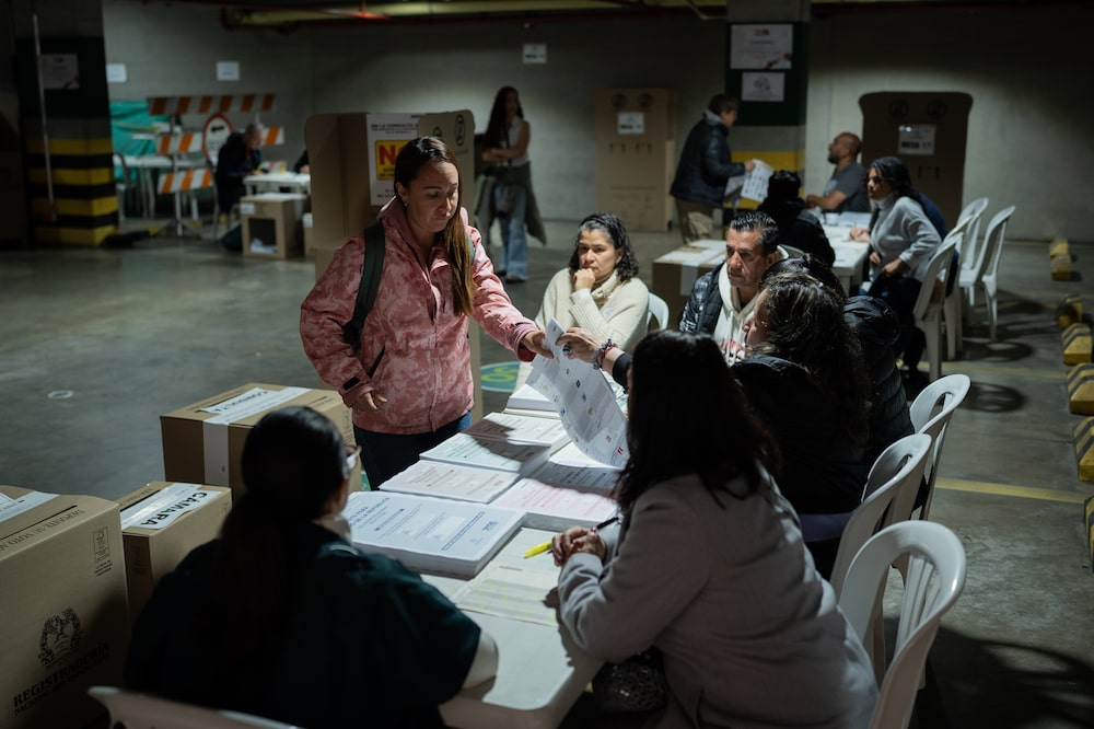 A voter checks in to cast a ballot at a polling station during the Colombia parliamentary and primary elections in Bogota, Colombia, on Sunday, March 8, 2026. Colombia's fractured political landscape heads into March 8 congressional elections and inter-party presidential primaries that will shape the political map ahead of a tightly contested presidential race on May 31, with a likely runoff on June 21. Photographer: Nathalia Angarita/Bloomberg A voter checks in to cast a ballot at a polling station during the Colombia parliamentary and primary elections in Bogota, Colombia, on Sunday, March 8, 2026. Colombia's fractured political landscape heads into March 8 congressional elections and inter-party presidential primaries that will shape the political map ahead of a tightly contested presidential race on May 31, with a likely runoff on June 21. Photographer: Nathalia Angarita/Bloomberg
