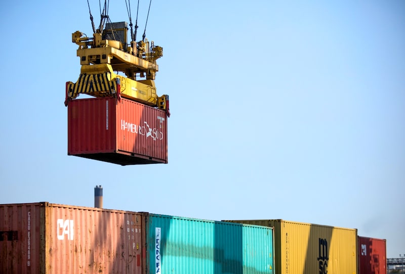 A crane moves a container at London Gateway port. A crane moves a container at London Gateway port.