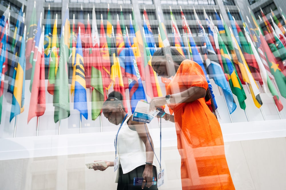Two attendees contemplate their place among the meeting of 191 nations during the 2026 Spring Meetings of the International Monetary Fund and the World Bank Group in Washington, DC, April 13, 2026. Two attendees contemplate their place among the meeting of 191 nations during the 2026 Spring Meetings of the International Monetary Fund and the World Bank Group in Washington, DC, April 13, 2026.