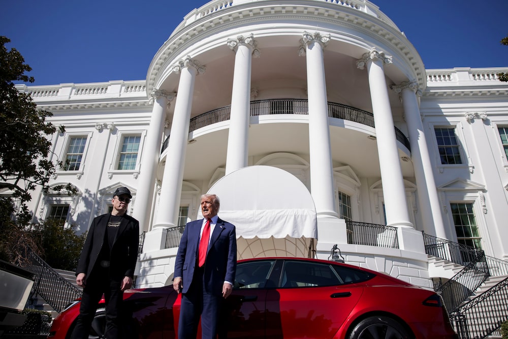 Elon Musk, chief executive officer of Tesla Inc., left, and US President Donald Trump speak to members of the media while looking at a Tesla Model S vehicle on the South Lawn of the White House in Washington, DC, US, on Tuesday, March 11, 2025. Elon Musk, chief executive officer of Tesla Inc., left, and US President Donald Trump speak to members of the media while looking at a Tesla Model S vehicle on the South Lawn of the White House in Washington, DC, US, on Tuesday, March 11, 2025.