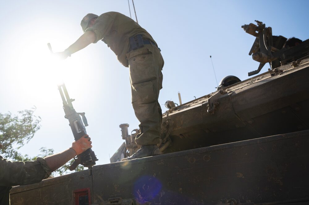 SOUTHERN ISRAEL - OCTOBER 21: An IDF soldier passes a heavy machine gun to another soldier from the top of a tank on October 21, 2023 in Southern Israel. Today marks two weeks since the kibbutzim and communities around the Gaza border, as well as the Super Nova party a were attacked by Hamas militants. As Israel prepares to invade the Gaza Strip in its campaign to vanquish Hamas, the Palestinian militant group that launched a deadly attack in southern Israel on October 7th, worries are growing of a wider war with multiple fronts, including at the country's northern border with Lebanon. Countries have scrambled to evacuate their citizens from Israel, and Israel has begun relocating residents some communities on its northern border. Meanwhile, hundreds of thousands of residents of northern Gaza have fled to the southern part of the territory, following Israel's vow to launch a ground invasion. (Photo by Alexi J. Rosenfeld/Getty Images) SOUTHERN ISRAEL - OCTOBER 21: An IDF soldier passes a heavy machine gun to another soldier from the top of a tank on October 21, 2023 in Southern Israel. Today marks two weeks since the kibbutzim and communities around the Gaza border, as well as the Super Nova party a were attacked by Hamas militants. As Israel prepares to invade the Gaza Strip in its campaign to vanquish Hamas, the Palestinian militant group that launched a deadly attack in southern Israel on October 7th, worries are growing of a wider war with multiple fronts, including at the country's northern border with Lebanon. Countries have scrambled to evacuate their citizens from Israel, and Israel has begun relocating residents some communities on its northern border. Meanwhile, hundreds of thousands of residents of northern Gaza have fled to the southern part of the territory, following Israel's vow to launch a ground invasion. (Photo by Alexi J. Rosenfeld/Getty Images)