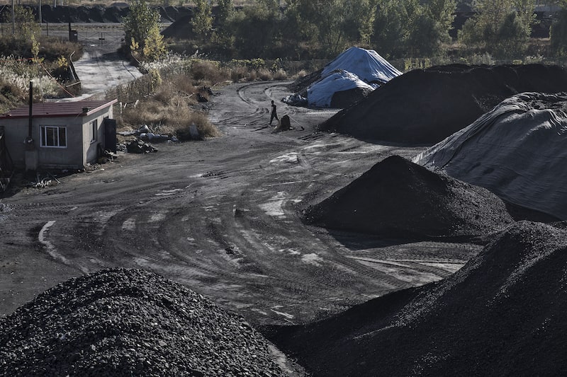 Pies of coal sit near the port facilities in Qinhuangdao, China, on Friday, 28 October 2016. Photographer: Qilai Shen/Bloomberg Pies of coal sit near the port facilities in Qinhuangdao, China, on Friday, 28 October 2016. Photographer: Qilai Shen/Bloomberg