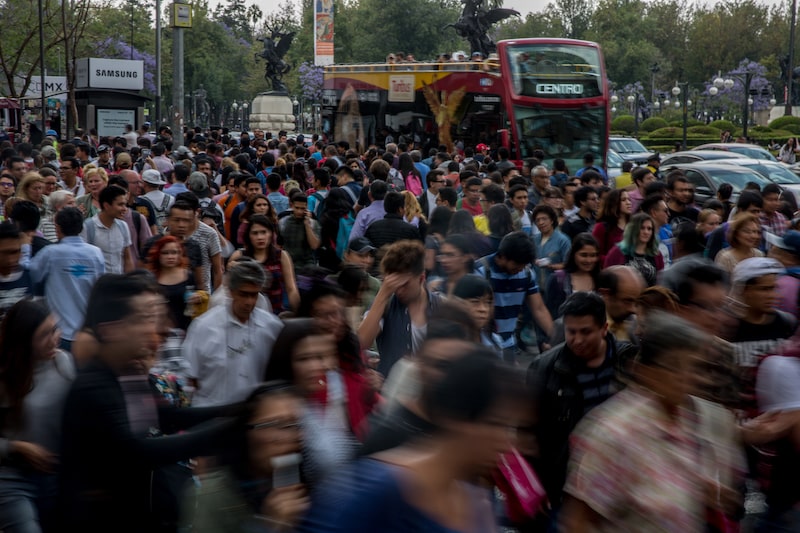 Pedestrians pass in front of a tour bus in Mexico City, Mexico, on Friday, April 13, 2018. Mexico's peso extended losses for a third day amid profit-taking outflows as the currency failed to stay strong past 18.00 key level. Photographer: Alejandro Cegarra/Bloomberg Pedestrians pass in front of a tour bus in Mexico City, Mexico, on Friday, April 13, 2018. Mexico's peso extended losses for a third day amid profit-taking outflows as the currency failed to stay strong past 18.00 key level. Photographer: Alejandro Cegarra/Bloomberg