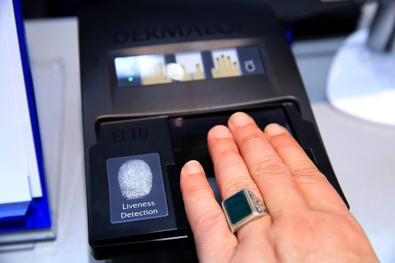 An exhibitor demonstrates the Dermalog LF-10 biometric fingerprint scanning device at the Dermalog Identification Systems GmbH pavilion at the CeBIT 2017 tech fair in Hannover, Germany, on Tuesday, March 21, 2017. Leading edge technologies in the digital world are showcased in this annual event which runs March 20 - 24. Photographer: Krisztian Bocsi/Bloomberg An exhibitor demonstrates the Dermalog LF-10 biometric fingerprint scanning device at the Dermalog Identification Systems GmbH pavilion at the CeBIT 2017 tech fair in Hannover, Germany, on Tuesday, March 21, 2017. Leading edge technologies in the digital world are showcased in this annual event which runs March 20 - 24. Photographer: Krisztian Bocsi/Bloomberg