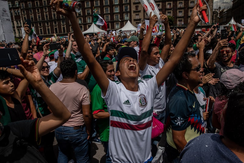 Soccer fans react while watching a monitor broadcasting the Group F opening match of the FIFA World Cup between Mexico and Germany at a viewing party in the Zocalo in Mexico City, Mexico, on Sunday, June 17, 2018. Mexico's Hirving Lozano goal gave his team a 1-0 stunning victor over World Cup defending champions Germany. Photographer: Alejandro Cegarra/Bloomberg Soccer fans react while watching a monitor broadcasting the Group F opening match of the FIFA World Cup between Mexico and Germany at a viewing party in the Zocalo in Mexico City, Mexico, on Sunday, June 17, 2018. Mexico's Hirving Lozano goal gave his team a 1-0 stunning victor over World Cup defending champions Germany. Photographer: Alejandro Cegarra/Bloomberg