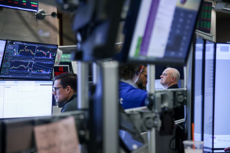 Traders work on the floor of the American Stock Exchange at the New York Stock Exchange. Traders work on the floor of the American Stock Exchange at the New York Stock Exchange.