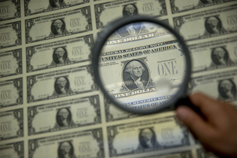A magnifying glass is held over a 50 subject one dollar note sheet after being printed by an intaglio printing press in this arranged photograph at the U.S. Bureau of Engraving and Printing in Washington, D.C., U.S., on Tuesday, April 14, 2015. Republican efforts to pass a fiscal year 2016 budget cleared another hurdle as the House named its members to a conference committee and Senate Majority Leader Mitch McConnell pledged to do the same by the end of the week. Photographer: Andrew Harrer/Bloomberg A magnifying glass is held over a 50 subject one dollar note sheet after being printed by an intaglio printing press in this arranged photograph at the U.S. Bureau of Engraving and Printing in Washington, D.C., U.S., on Tuesday, April 14, 2015. Republican efforts to pass a fiscal year 2016 budget cleared another hurdle as the House named its members to a conference committee and Senate Majority Leader Mitch McConnell pledged to do the same by the end of the week. Photographer: Andrew Harrer/Bloomberg