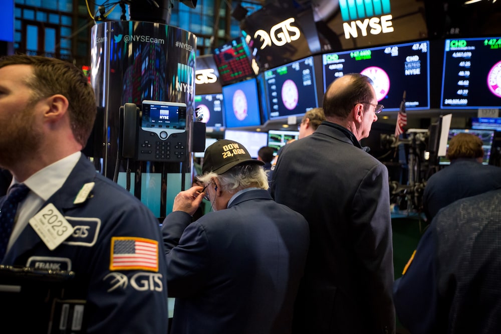 A trader wears a "DOW 23,000" hat on the floor of the New York Stock Exchange (NYSE) in New York, U.S., on Monday, Feb. 5, 2018. U.S. stocks plunged, sending the Dow Jones Industrial Average down almost 1,600 points, as major averages erased gains for the year. Photographer: Michael Nagle/Bloomberg A trader wears a "DOW 23,000" hat on the floor of the New York Stock Exchange (NYSE) in New York, U.S., on Monday, Feb. 5, 2018. U.S. stocks plunged, sending the Dow Jones Industrial Average down almost 1,600 points, as major averages erased gains for the year. Photographer: Michael Nagle/Bloomberg