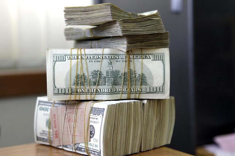 U.S. one hundred dollar notes stand in bundles at a branch of the Bank of Palestine Plc in Bethlehem, Palestinian Authority, on Monday, Aug. 1, 2011. By winning her self-confidence and the confidence of her customers, Reem Quaraqe, a bank teller, is helping to fulfill the vision of the Bank of Palestine's 35-year-old Chairman and Chief Executive Officer, Hashim Shawa. Photographer: Ariel Jerozolimski/Bloomberg
U.S. one hundred dollar notes stand in bundles at a branch of the Bank of Palestine Plc in Bethlehem, Palestinian Authority, on Monday, Aug. 1, 2011. By winning her self-confidence and the confidence of her customers, Reem Quaraqe, a bank teller, is helping to fulfill the vision of the Bank of Palestine's 35-year-old Chairman and Chief Executive Officer, Hashim Shawa. Photographer: Ariel Jerozolimski/Bloomberg