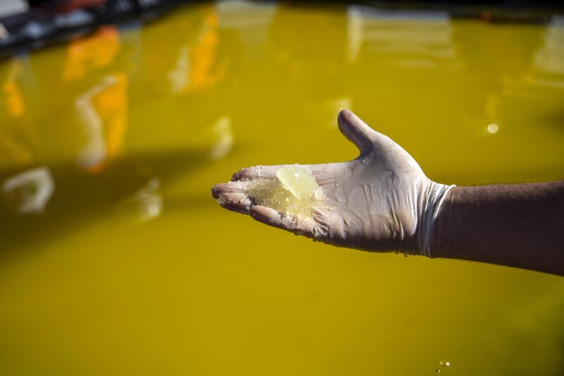 A gloved hand holds traces of lithium concentrate at a lithium mine in the Atacama Desert, Chile. A gloved hand holds traces of lithium concentrate at a lithium mine in the Atacama Desert, Chile.