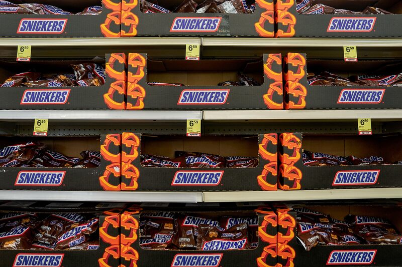 Bags of Mars Inc's Snickers bars at a store in the Harlem neighborhood of New York, US, on Wednesday, Aug. 14, 2024. Mars Inc. agreed to buy Kellanova for nearly $36 billion including debt, bringing together two major food companies in the biggest deal of the year. Photographer: Bing Guan/Bloomberg Bags of Mars Inc's Snickers bars at a store in the Harlem neighborhood of New York, US, on Wednesday, Aug. 14, 2024. Mars Inc. agreed to buy Kellanova for nearly $36 billion including debt, bringing together two major food companies in the biggest deal of the year. Photographer: Bing Guan/Bloomberg