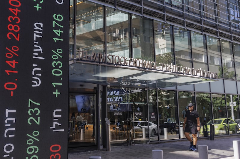An electronic ticker displays stock price information on a totem sign outside the Tel Aviv Stock Exchange in Tel Aviv, Israel, on Tuesday, Nov. 7, 2023. Israels shekel has recouped the bulk of its losses since the war between Israel and Hamas began a month ago, with the central banks support helping to tame volatility and discourage bets against it. An electronic ticker displays stock price information on a totem sign outside the Tel Aviv Stock Exchange in Tel Aviv, Israel, on Tuesday, Nov. 7, 2023. Israels shekel has recouped the bulk of its losses since the war between Israel and Hamas began a month ago, with the central banks support helping to tame volatility and discourage bets against it.