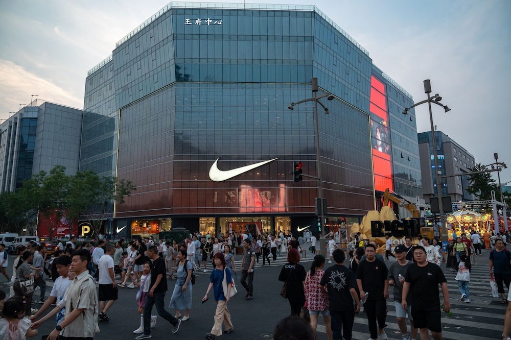 Pedestrians pass a Nike Inc. store in the Wangfujing shopping area in Beijing, China, on Monday, July 11, 2024. China's economic growth likely weakened in the second quarter, with headwinds adding pressure on Chinese leaders to lift confidence at a twice-a-decade policy meeting next week. Source: Bloomberg Pedestrians pass a Nike Inc. store in the Wangfujing shopping area in Beijing, China, on Monday, July 11, 2024. China's economic growth likely weakened in the second quarter, with headwinds adding pressure on Chinese leaders to lift confidence at a twice-a-decade policy meeting next week. Source: Bloomberg