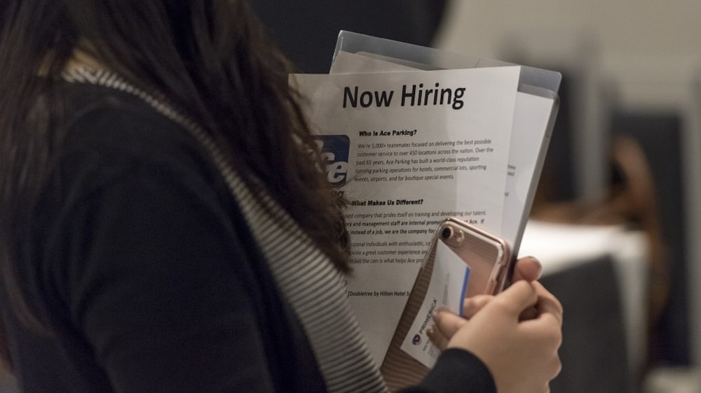 A job seeker holds a "Now Hiring" information sheet while talking to a recruiter during a Coast-to-Coast career fair in San Jose, California, U.S., on Wednesday, July 19, 2017. The U.S. Department of Labor will release jobless claims figures on July 20. Photographer: David Paul Morris/Bloomberg via Getty Images A job seeker holds a "Now Hiring" information sheet while talking to a recruiter during a Coast-to-Coast career fair in San Jose, California, U.S., on Wednesday, July 19, 2017. The U.S. Department of Labor will release jobless claims figures on July 20. Photographer: David Paul Morris/Bloomberg via Getty Images