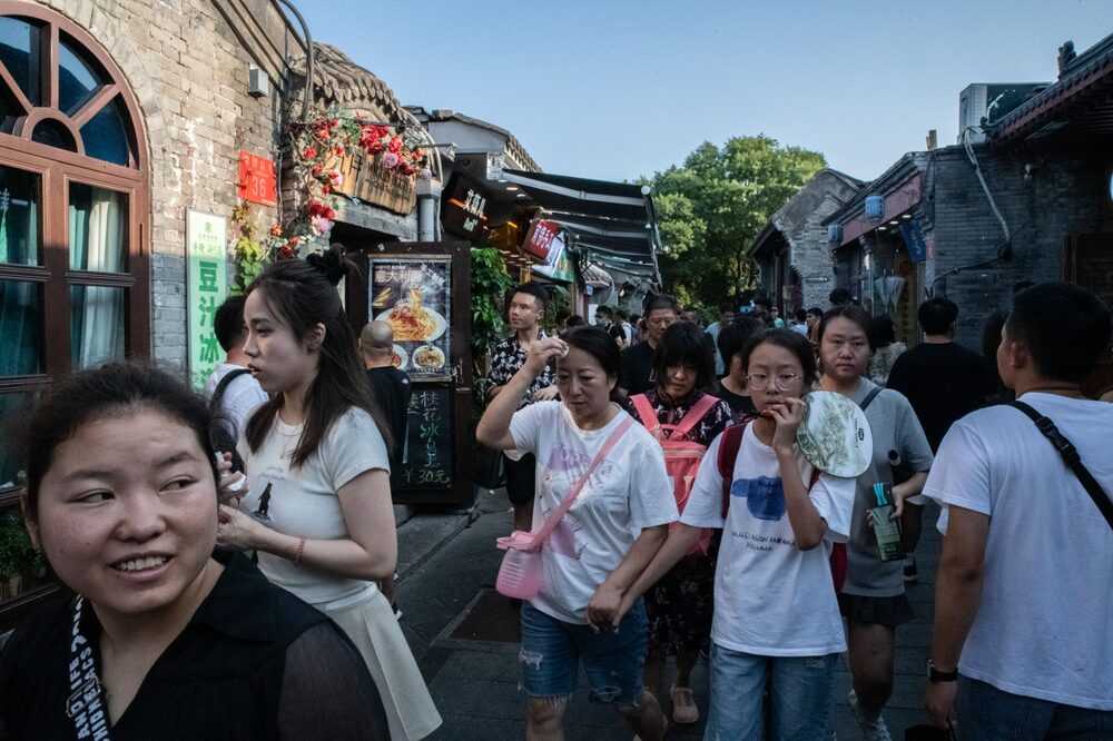 Visitors in Nanluoguxiang, an alleyway popular with tourists, in Beijing. Source: Bloomberg Visitors in Nanluoguxiang, an alleyway popular with tourists, in Beijing. Source: Bloomberg