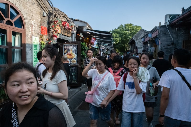 Visitors in Nanluoguxiang, an alleyway popular with tourists, in Beijing. Source: Bloomberg Visitors in Nanluoguxiang, an alleyway popular with tourists, in Beijing. Source: Bloomberg