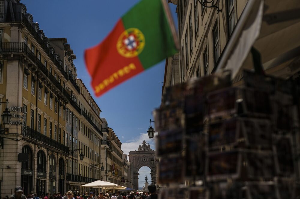 A Portuguese national flag hangs on display outside a tourist store near the Augusta street arch in the Baixa district in Lisbon, Portugal, on Monday, July 30, 2018. The revival in Lisbons downtown property market began after the previous government eased long-held rent controls in 2011 and started offering residence permits and tax breaks to foreigners. Photographer: Patricia de Melo Moreira/Bloomberg A Portuguese national flag hangs on display outside a tourist store near the Augusta street arch in the Baixa district in Lisbon, Portugal, on Monday, July 30, 2018. The revival in Lisbons downtown property market began after the previous government eased long-held rent controls in 2011 and started offering residence permits and tax breaks to foreigners. Photographer: Patricia de Melo Moreira/Bloomberg