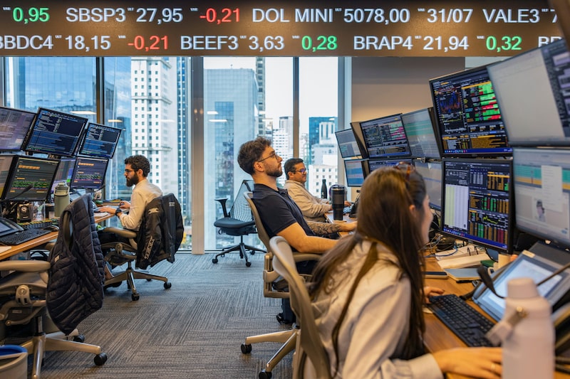 Employees work on the trading floor at the Genial Investments headquarters in Sao Paulo, Brazil, on Wednesday, Aug. 5, 2026. Brazilian economists cut their 2026 year-end benchmark interest rate forecast as Latin America's largest economy shows mounting signs of cooling down. Photographer: Victor Moriyama/Bloomberg Employees work on the trading floor at the Genial Investments headquarters in Sao Paulo, Brazil, on Wednesday, Aug. 5, 2026. Brazilian economists cut their 2026 year-end benchmark interest rate forecast as Latin America's largest economy shows mounting signs of cooling down. Photographer: Victor Moriyama/Bloomberg