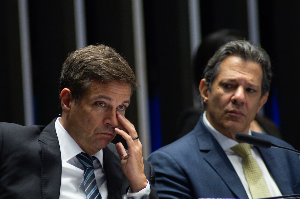 Roberto Campos Neto, Brazil's Central Bank president, left, and Fernando Haddad, Brazil's finance minister, attend a Senate debate at the National Congress in Brasilia, Brazil, on Thursday, April 27, 2023. Haddad has joined Lula in criticizing the central bank for keeping rates at a six-year high. Roberto Campos Neto, Brazil's Central Bank president, left, and Fernando Haddad, Brazil's finance minister, attend a Senate debate at the National Congress in Brasilia, Brazil, on Thursday, April 27, 2023. Haddad has joined Lula in criticizing the central bank for keeping rates at a six-year high.
