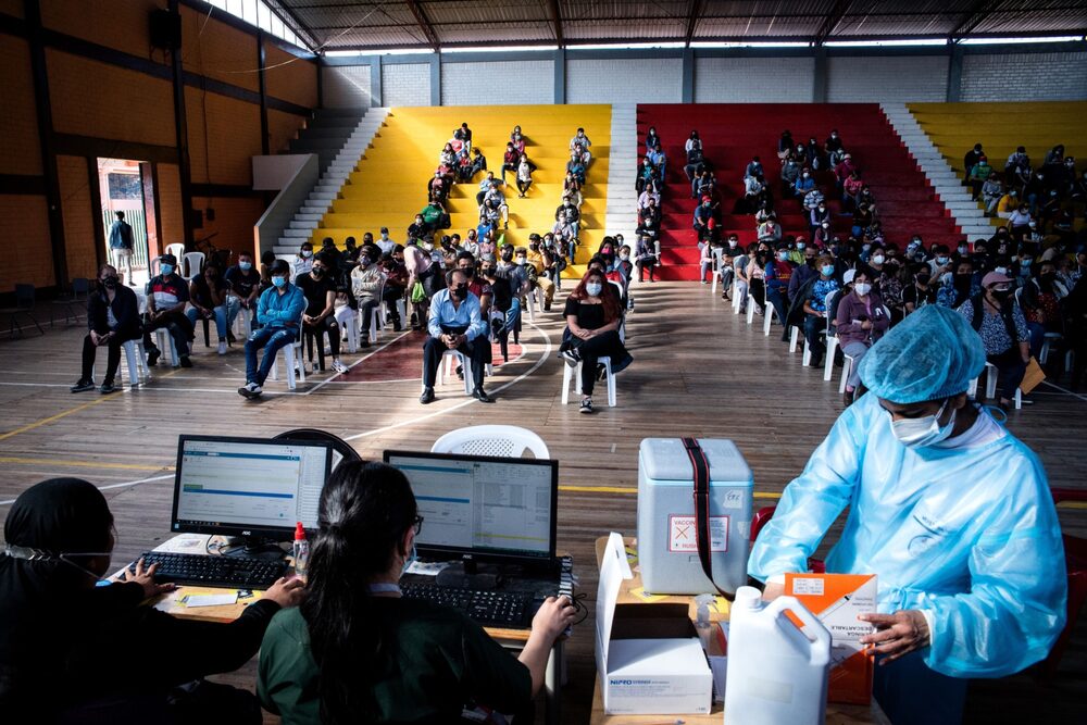 Residents wait in line to receive a Covid-19 vaccine dose at the Consejo Provincial High School vaccination site in Quito, Ecuador, on Saturday, July 31, 2021. Residents wait in line to receive a Covid-19 vaccine dose at the Consejo Provincial High School vaccination site in Quito, Ecuador, on Saturday, July 31, 2021.