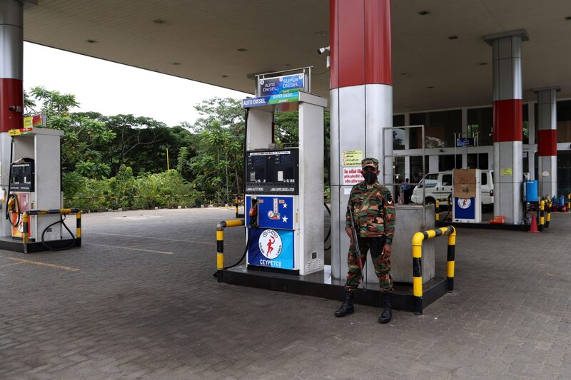 A soldier guards a fuel pump after a gas station ran out of gasoline in Kandy, Sri Lanka, on Friday, June 17, 2022. The government of Sri Lanka declared Friday a holiday for public offices and schools to curtail vehicular movement as the country, facing its worst financial crisis, runs out of fuel for transport and there’s little signs of fresh supplies coming in. Photographer: Buddhika Weerasinghe/Bloomberg A soldier guards a fuel pump after a gas station ran out of gasoline in Kandy, Sri Lanka, on Friday, June 17, 2022. The government of Sri Lanka declared Friday a holiday for public offices and schools to curtail vehicular movement as the country, facing its worst financial crisis, runs out of fuel for transport and there’s little signs of fresh supplies coming in. Photographer: Buddhika Weerasinghe/Bloomberg