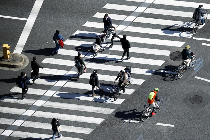 Pedestrians cross a road in Tokyo. Photographer: Kiyoshi Ota/Bloomberg Pedestrians cross a road in Tokyo. Photographer: Kiyoshi Ota/Bloomberg