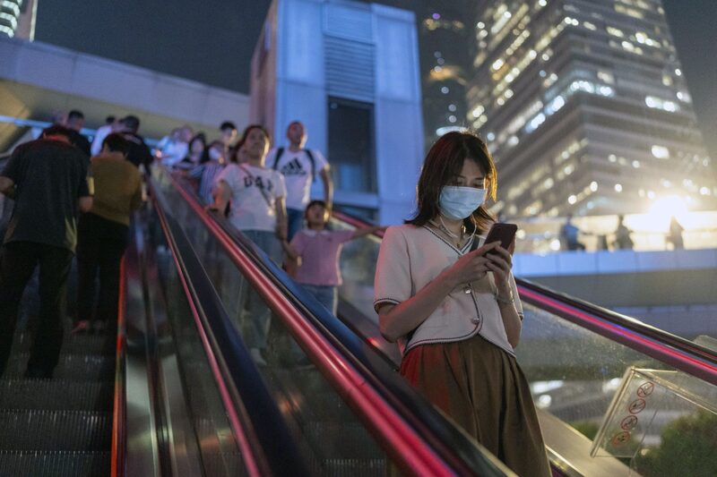 Pedestres andam em escadas rolantes no distrito financeiro de Lujiazui, em Xangai, China Pedestres andam em escadas rolantes no distrito financeiro de Lujiazui, em Xangai, China