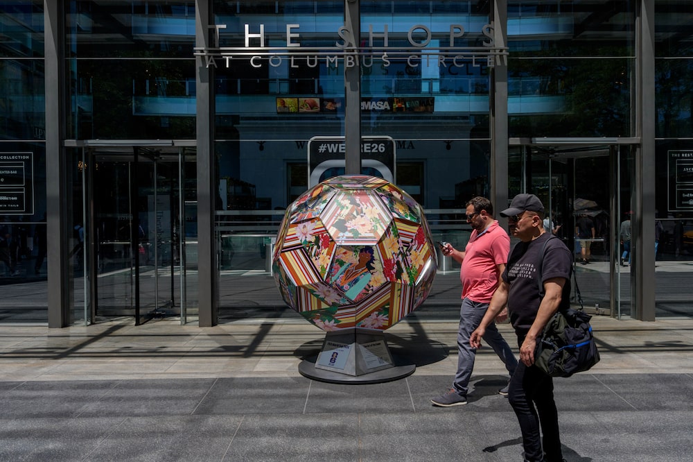 Signage and a football art piece for the FIFA World Cup at The Shops at Columbus Circle in New York, US, on Thursday, June 4, 2026. New Jersey Transit will reduce its controversial $150 World Cup ticket price to $105 after widespread pushback. Photographer: Adam Gray/Bloomberg Signage and a football art piece for the FIFA World Cup at The Shops at Columbus Circle in New York, US, on Thursday, June 4, 2026. New Jersey Transit will reduce its controversial $150 World Cup ticket price to $105 after widespread pushback. Photographer: Adam Gray/Bloomberg