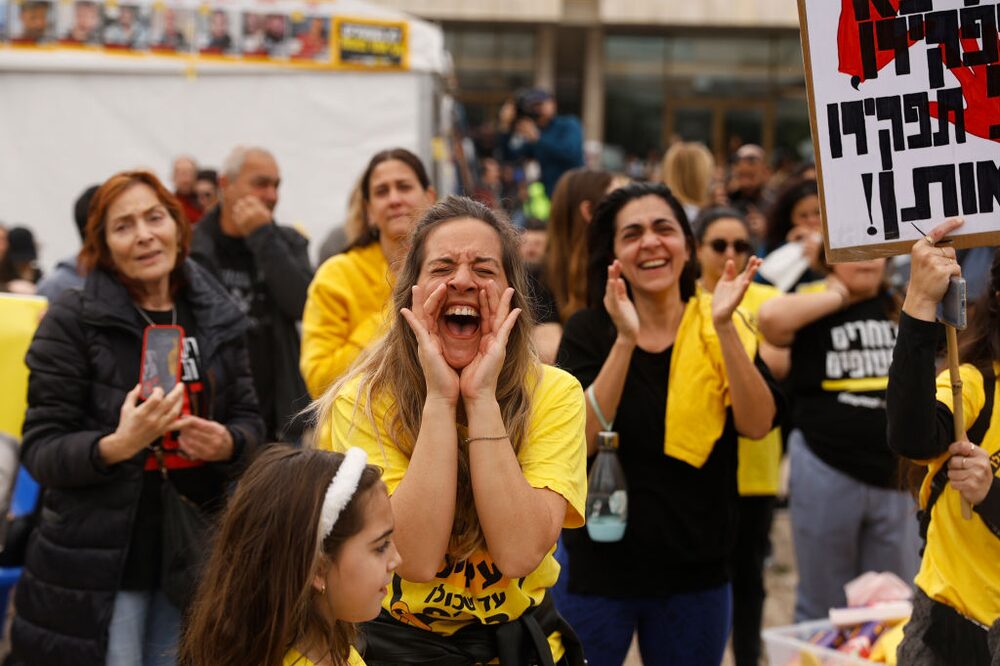 TEL AVIV, ISRAEL - JANUARY 25: People react and hold up photos at Hostages square while watching live streaming of the release of the hostages on January 25, 2025 in Tel Aviv, Israel. Today brings the release of four more Israeli hostages held by Hamas in Gaza, the second such exchange under the current ceasefire agreement that began one week ago. (Photo by Amir Levy/Getty Images) TEL AVIV, ISRAEL - JANUARY 25: People react and hold up photos at Hostages square while watching live streaming of the release of the hostages on January 25, 2025 in Tel Aviv, Israel. Today brings the release of four more Israeli hostages held by Hamas in Gaza, the second such exchange under the current ceasefire agreement that began one week ago. (Photo by Amir Levy/Getty Images)