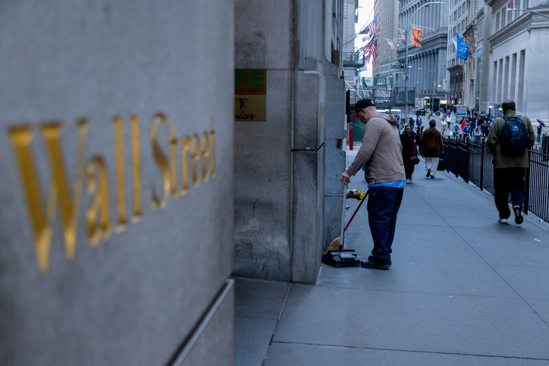 Trabalhador varre a rua Wall Street em frente à Bolsa de Valores de Nova York (NYSE), em Nova York, EUA, na segunda-feira Trabalhador varre a rua Wall Street em frente à Bolsa de Valores de Nova York (NYSE), em Nova York, EUA, na segunda-feira