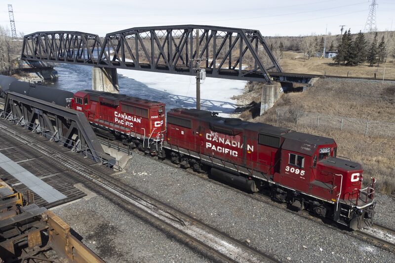 A Canadian Pacific Railway locomotive travels across a bridge in Calgary, Alberta, Canada. A Canadian Pacific Railway locomotive travels across a bridge in Calgary, Alberta, Canada.