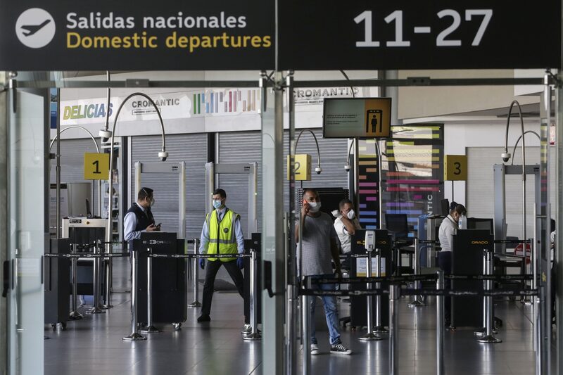 Funcionarios de seguridad con máscaras protectoras se paran frente a un puesto de control de seguridad en el Aeropuerto Internacional El Dorado en Bogotá, Colombia, el domingo 22 de marzo de 2020. Funcionarios de seguridad con máscaras protectoras se paran frente a un puesto de control de seguridad en el Aeropuerto Internacional El Dorado en Bogotá, Colombia, el domingo 22 de marzo de 2020.