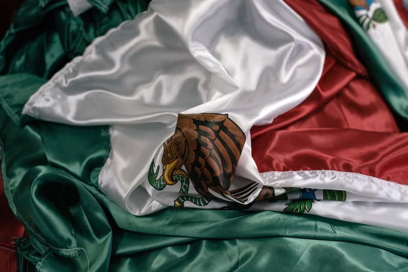 A Mexican national flag lies folded on a table in Toluca, Mexico. Photographer: Luis Antonio Rojas/Bloomberg A Mexican national flag lies folded on a table in Toluca, Mexico. Photographer: Luis Antonio Rojas/Bloomberg