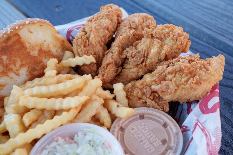 Raising Cane's food arranged at a restaurant in Los Angeles, California, US, on Wednesday, Sept. 4, 2024. Raising Cane's Restaurants LLC has told debt investors its revenue increased more than 30% in the first six months of this year as it continues to expand its footprint, according to people familiar with the matter. Photographer: Eric Thayer/Bloomberg Raising Cane's food arranged at a restaurant in Los Angeles, California, US, on Wednesday, Sept. 4, 2024. Raising Cane's Restaurants LLC has told debt investors its revenue increased more than 30% in the first six months of this year as it continues to expand its footprint, according to people familiar with the matter. Photographer: Eric Thayer/Bloomberg