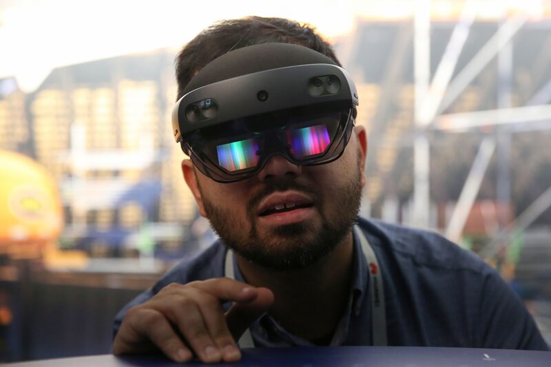 A person wears a Microsoft Corp. HoloLens 2 headset. A person wears a Microsoft Corp. HoloLens 2 headset.