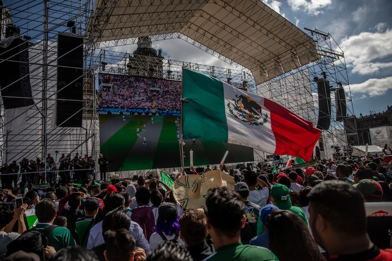 A soccer fan waves a Mexican flag while watching a monitor broadcasting the Group F opening match of the FIFA World Cup between Mexico and Germany at a viewing party in the Zocalo in Mexico City, Mexico, on Sunday, June 17, 2018. Mexico's Hirving Lozano goal gave his team a 1-0 stunning victor over World Cup defending champions Germany. Photographer: Alejandro Cegarra/Bloomberg A soccer fan waves a Mexican flag while watching a monitor broadcasting the Group F opening match of the FIFA World Cup between Mexico and Germany at a viewing party in the Zocalo in Mexico City, Mexico, on Sunday, June 17, 2018. Mexico's Hirving Lozano goal gave his team a 1-0 stunning victor over World Cup defending champions Germany. Photographer: Alejandro Cegarra/Bloomberg
