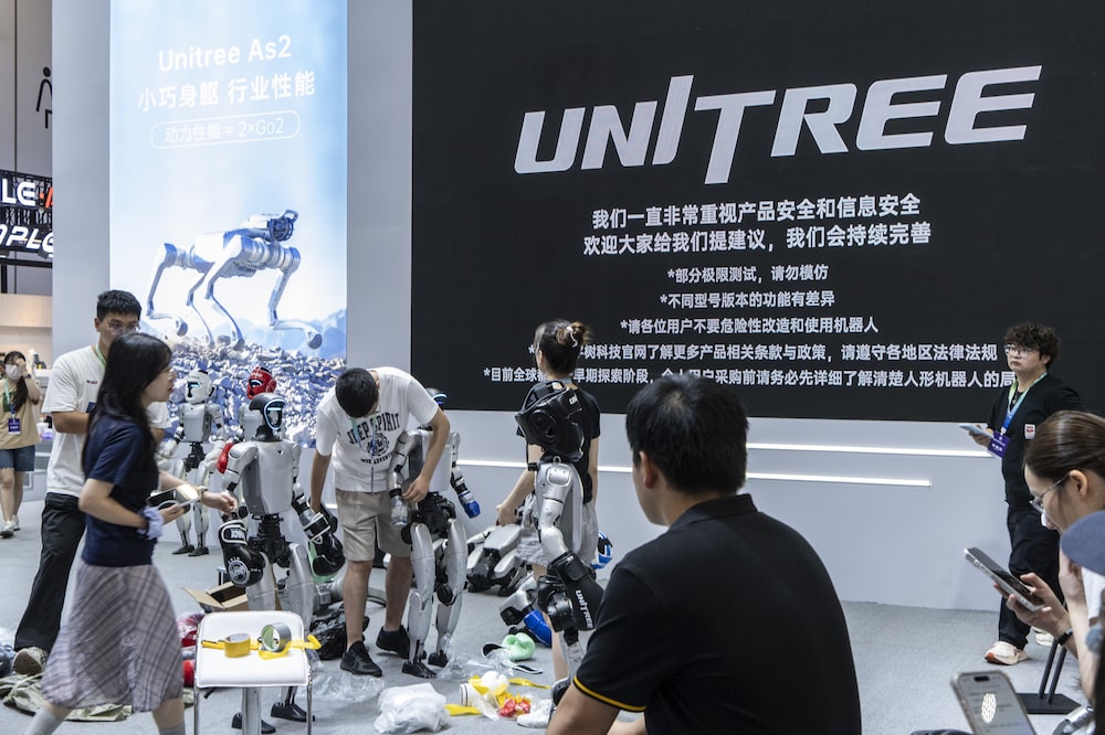 Technicians install a Unitree Robotics G1 humanoid robot at the company's booth ahead of the opening of the World Robot Conference in Beijing, China, on Tuesday, Aug. 18, 2026. Embodied artificial intelligence is emerging as one of the most closely watched frontiers in the global AI race as Beijing steps up support for strategic technologies ranging from semiconductors to humanoid robots. Photographer: Qilai Shen/Bloomberg Technicians install a Unitree Robotics G1 humanoid robot at the company's booth ahead of the opening of the World Robot Conference in Beijing, China, on Tuesday, Aug. 18, 2026. Embodied artificial intelligence is emerging as one of the most closely watched frontiers in the global AI race as Beijing steps up support for strategic technologies ranging from semiconductors to humanoid robots. Photographer: Qilai Shen/Bloomberg